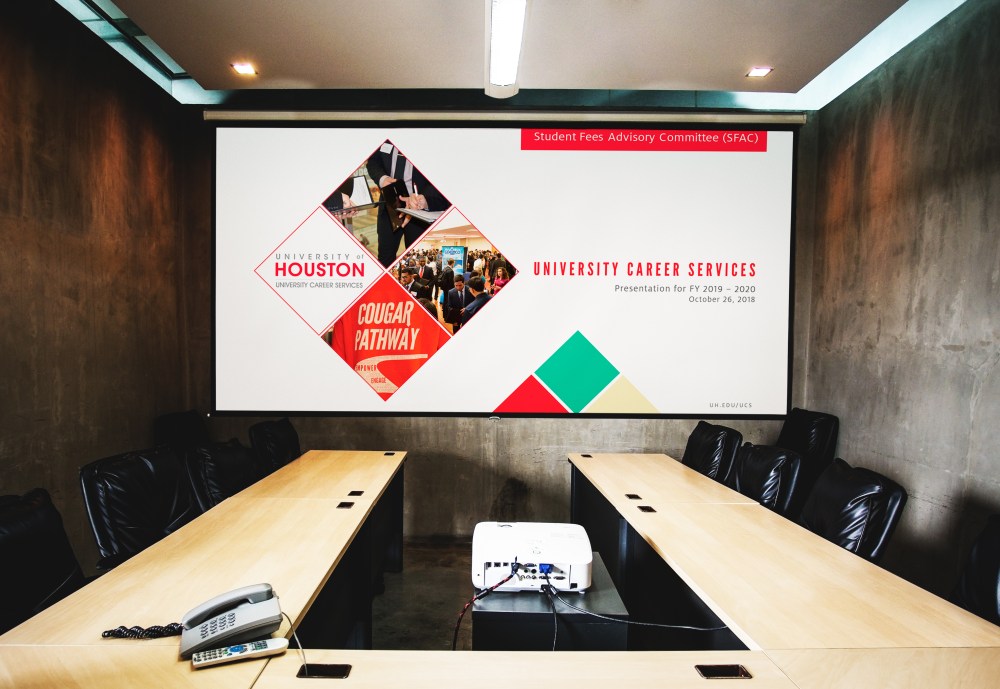 Blank white projector screen mockup in a meeting room